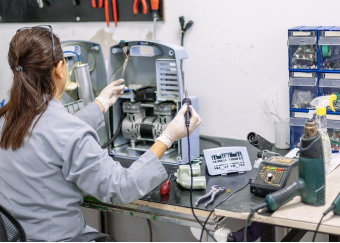 An experienced biomedical engineer repairing equipment