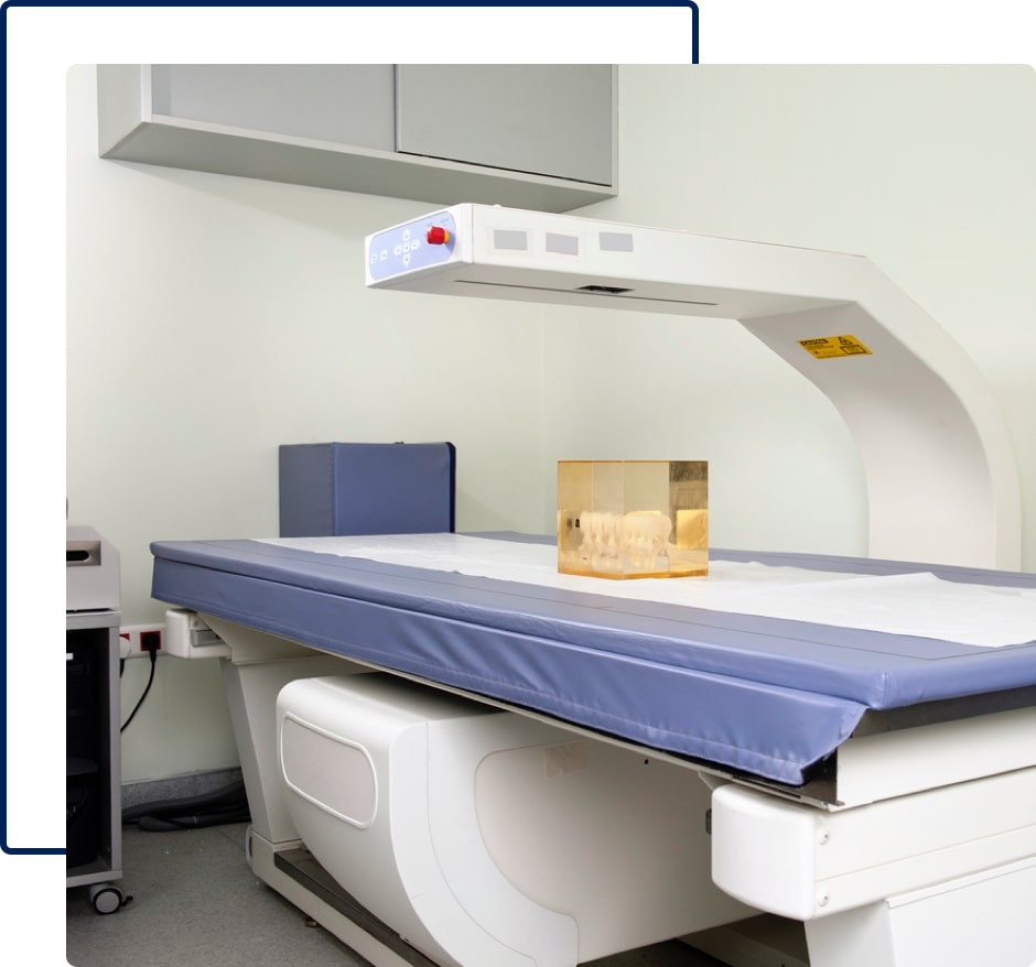 Bone densitometer with an X-ray arm and a table.
