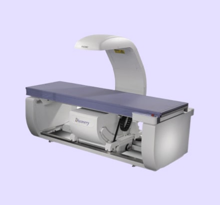 A bone densitometer machine with an X-ray arm.