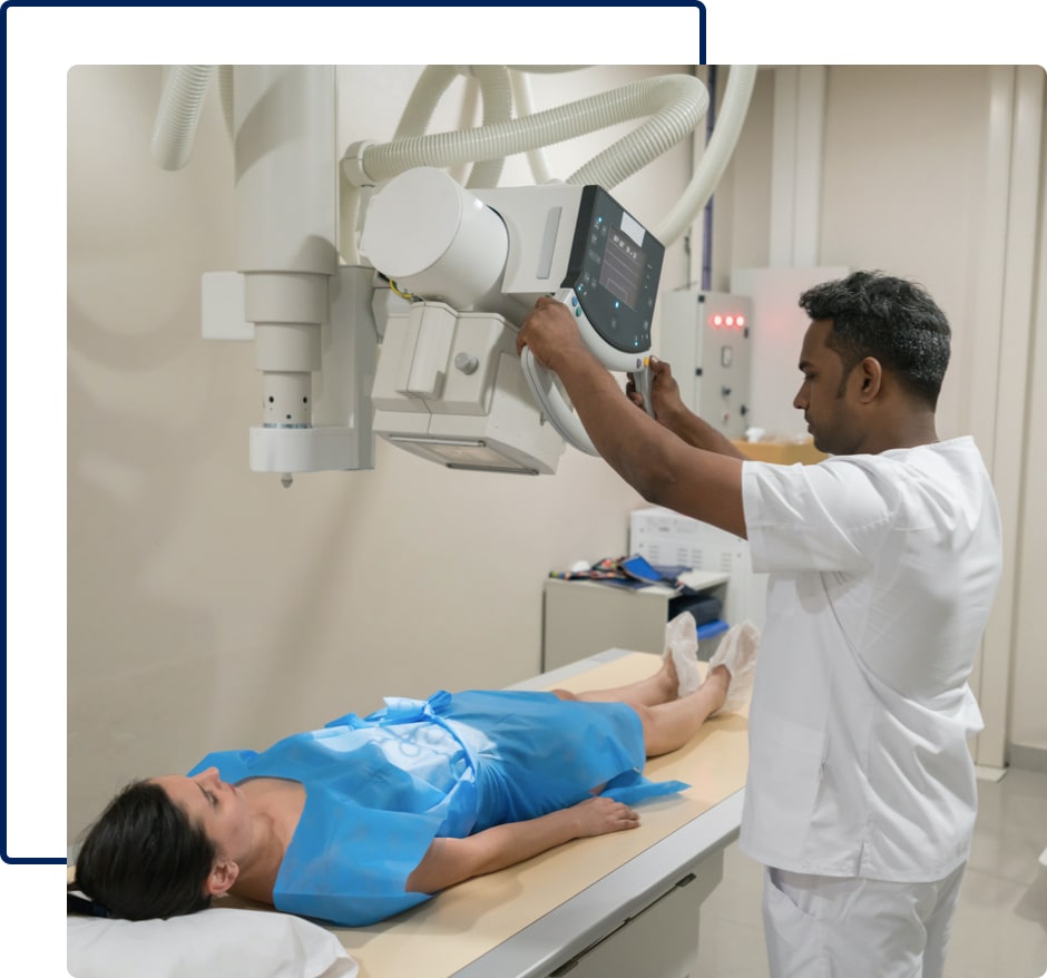 A male medical technician uses an x-ray machine on a female patient.